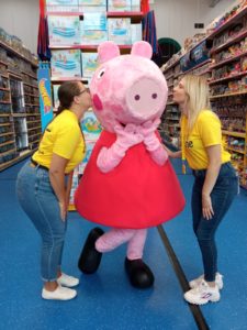 Two women in Rays of Sunshine t-shirts blowing a kiss to Peppa Pig who is in the middle