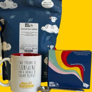 Package of loose leaf tea sits alongside a pack of tea bags and a white Rays of Sunshine mug