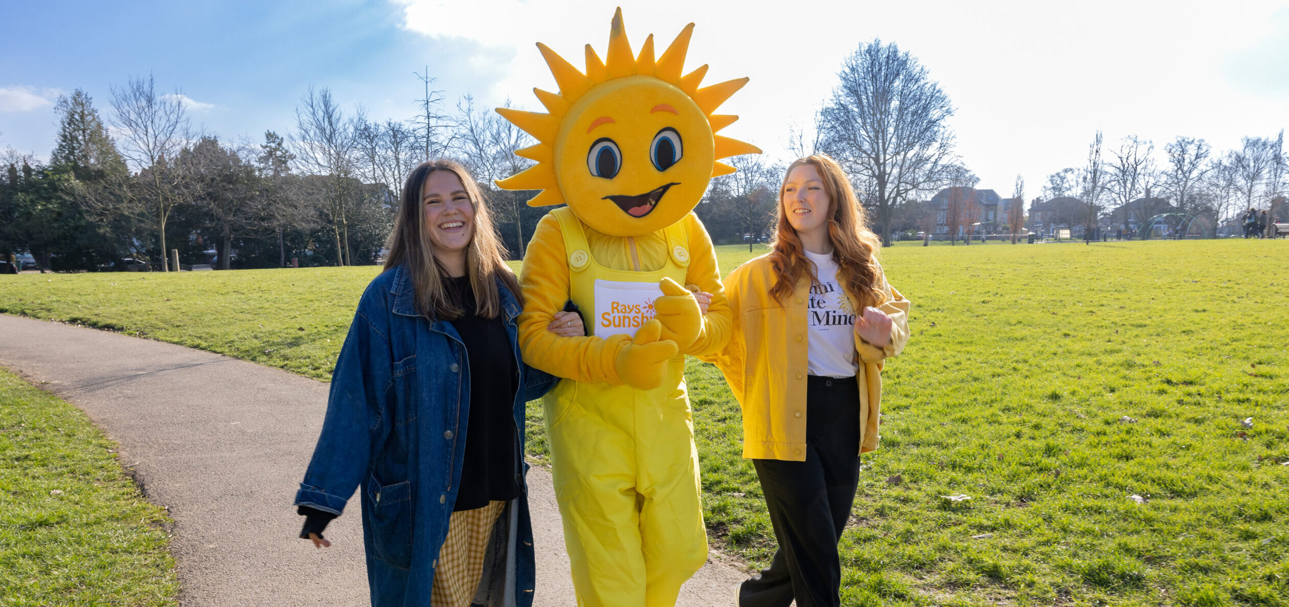 Rays of Sunshine's mascot Sunny walking with two of our wish granters