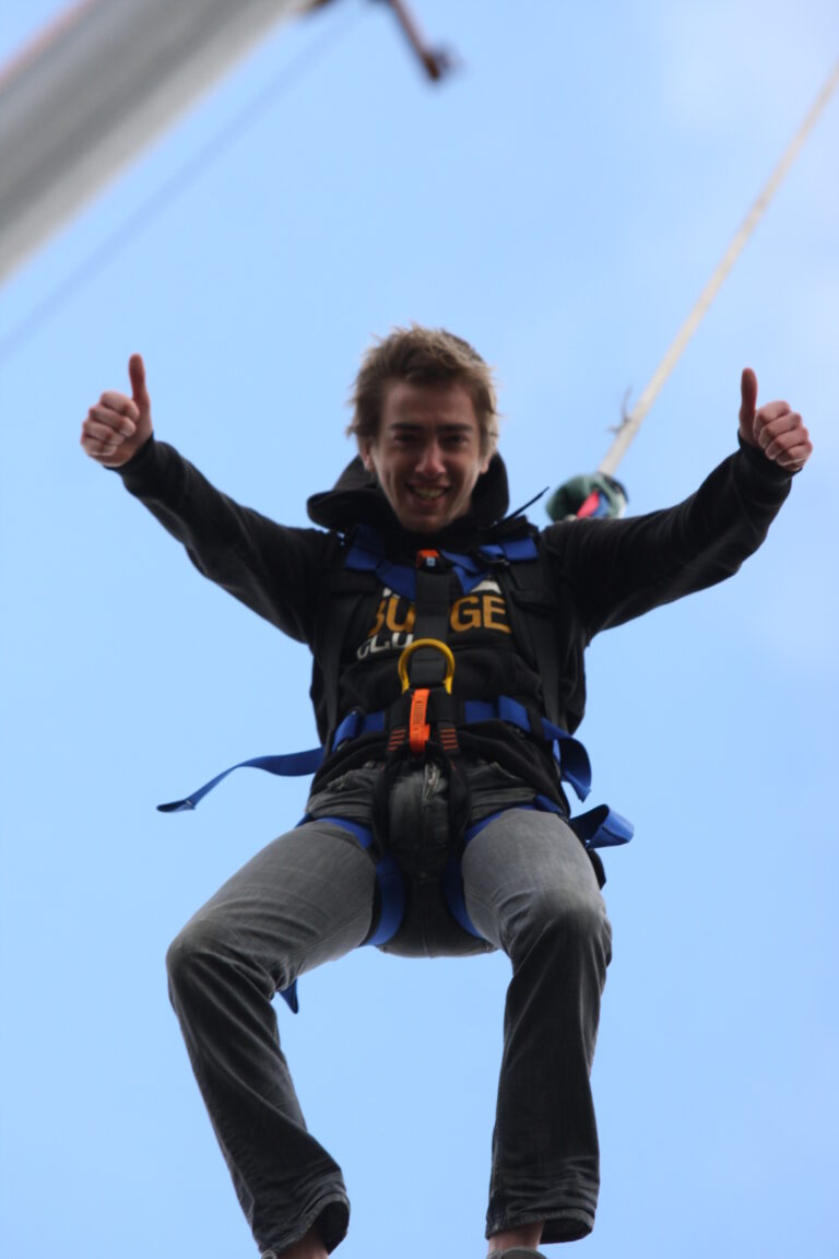 man giving thumbs up to camera as he bungee jump