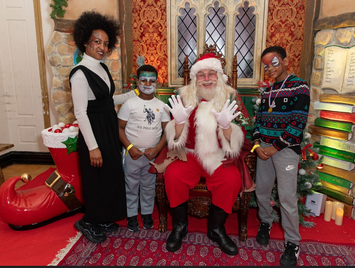 A family meeting santa in a grotto