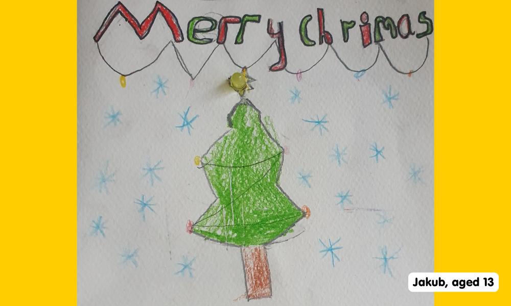 Child's drawing of a Christmas tree and the words Merry Crimas