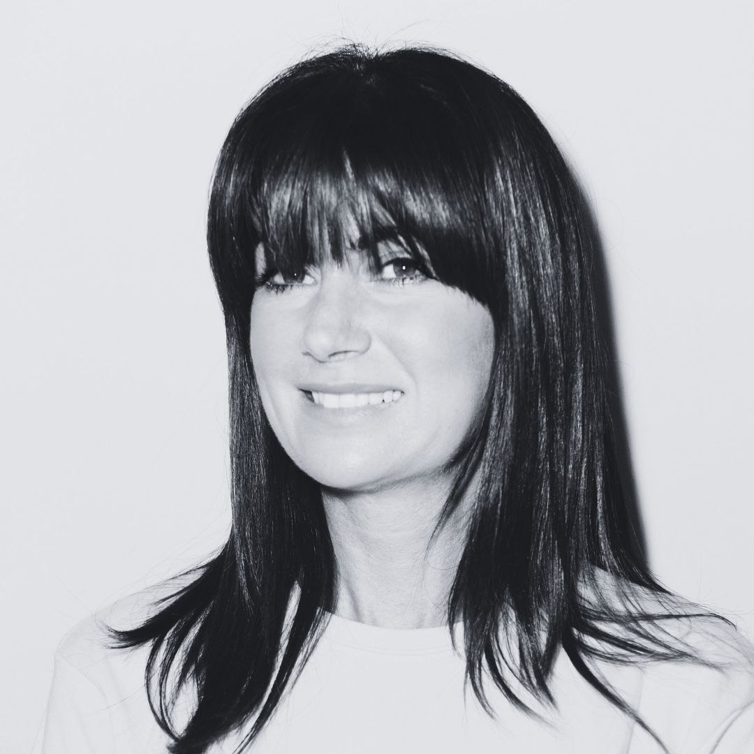 Headshot of Hayley Allan smiling to camera in black and white