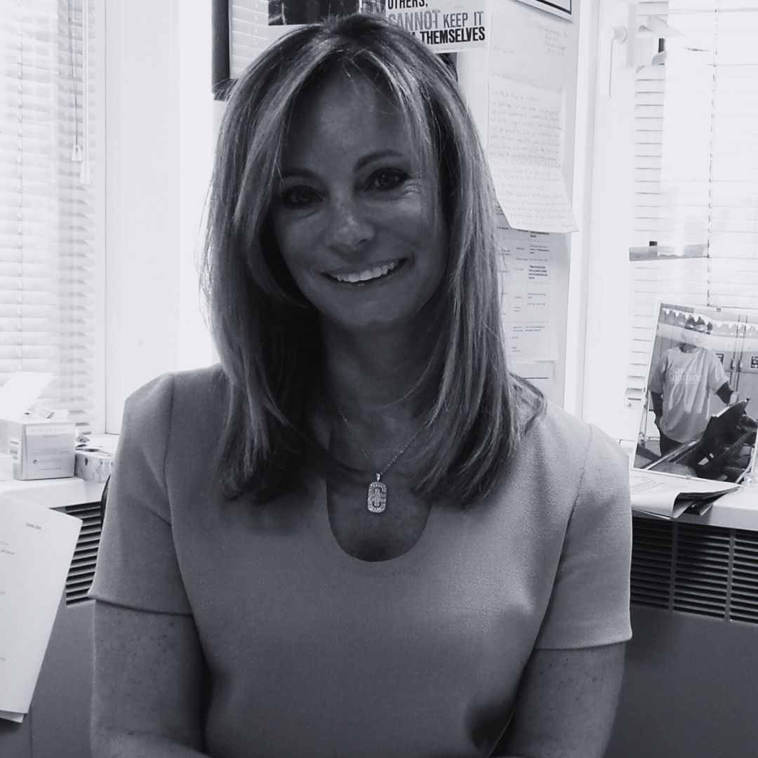 Headshot of Jayne Sharpe smiling to camera in black & white