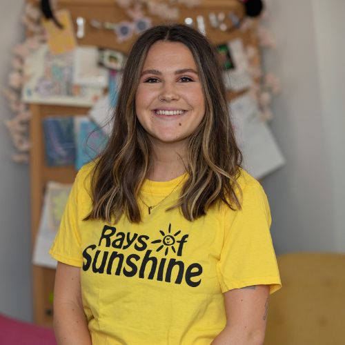 Ellie wearing the Rays of Sunshine t-shirt. She is standing