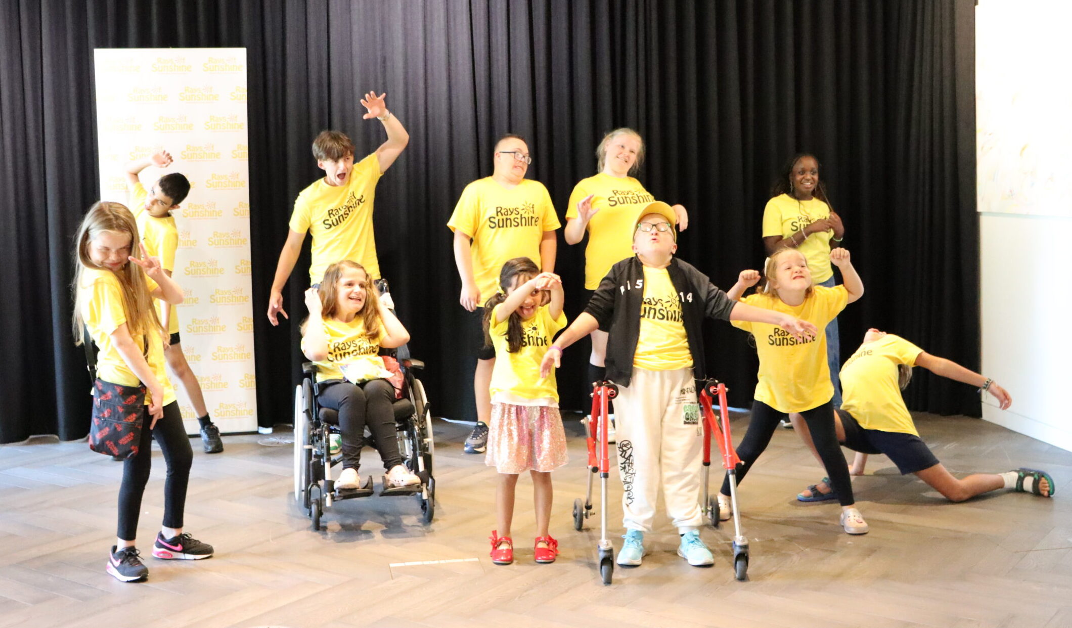 Shot of group of children, all in yellow Rays of Sunshine t-shirts.