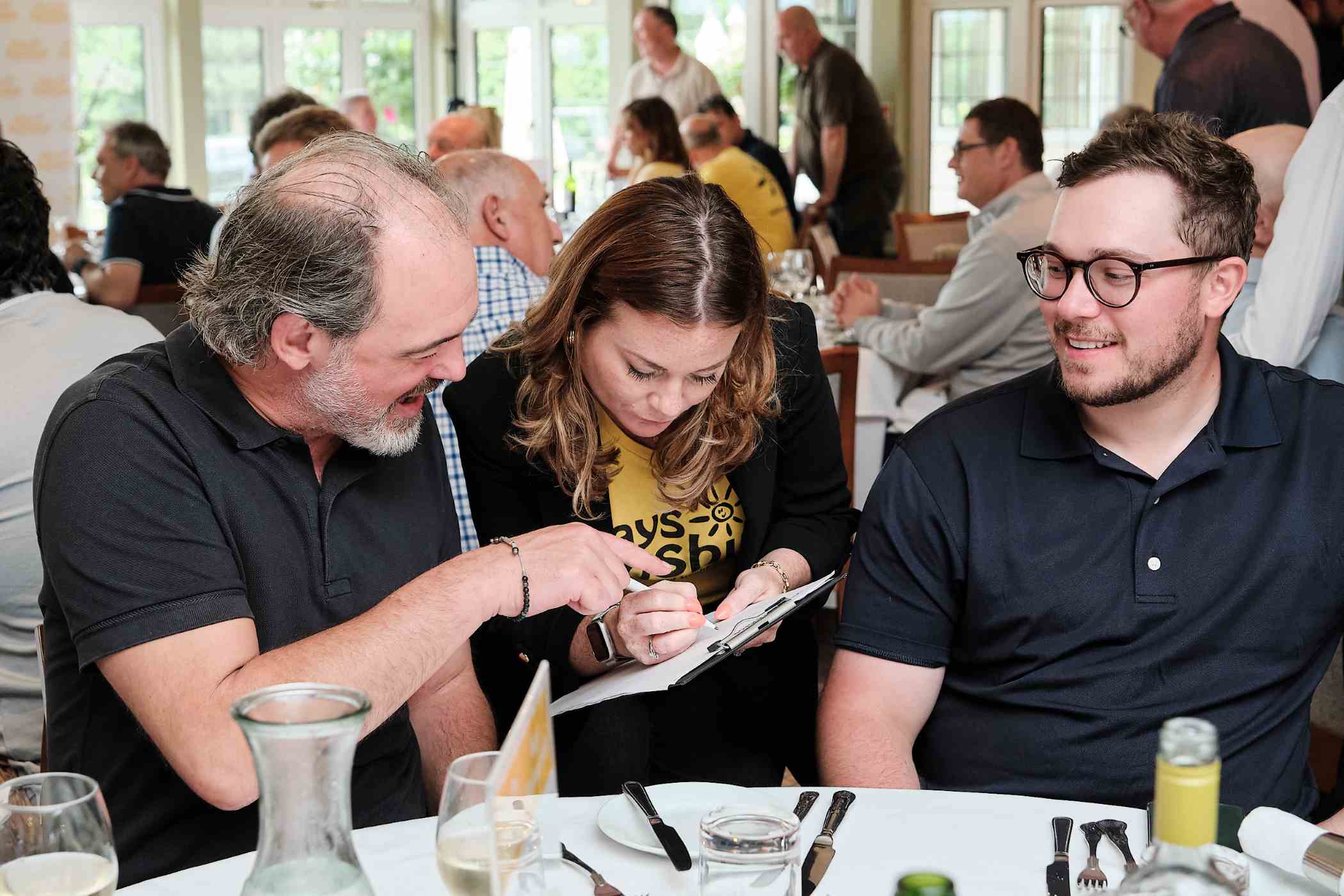 Three people together talking.