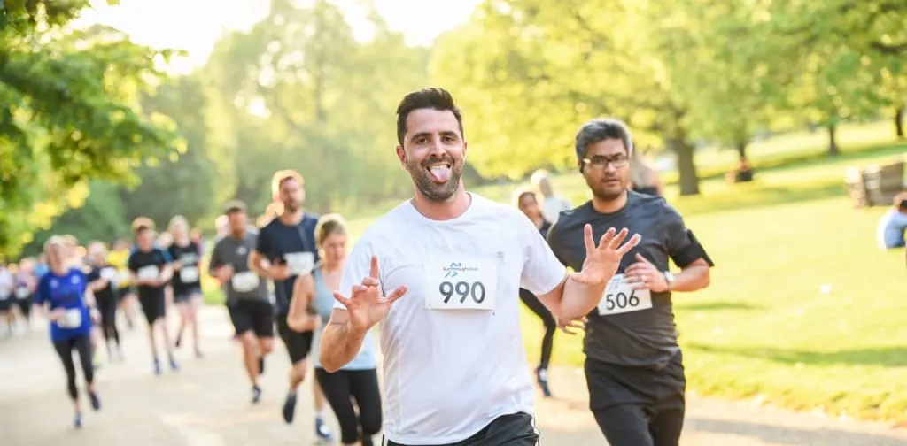 Man running with his tounge sticking out.