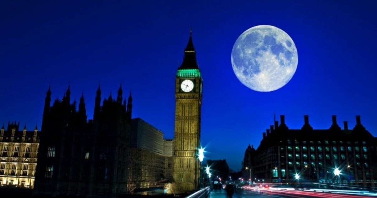 big ben at night with moon lit up