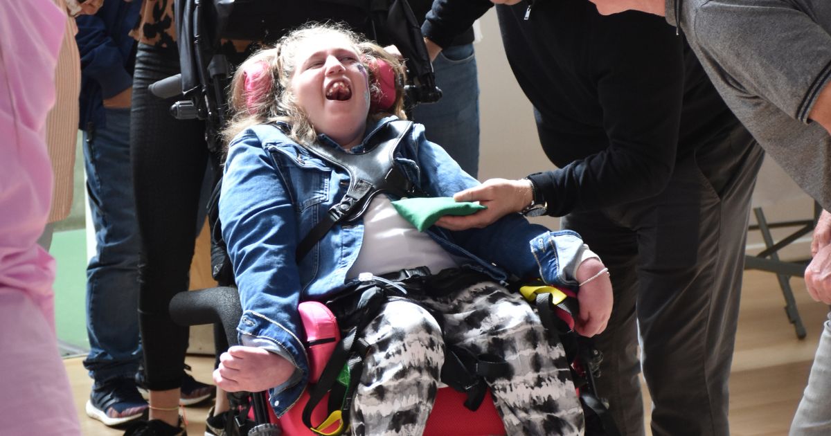 Teen girl in wheelchair smiling