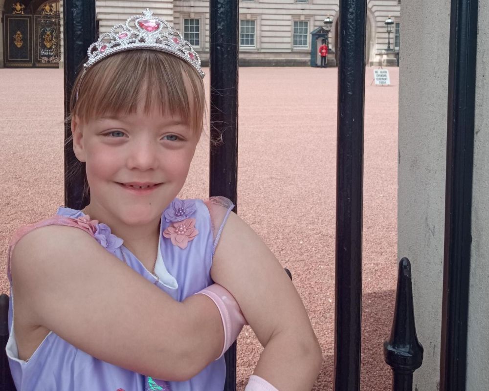 Little girl in tiara outside Buckingham Palace