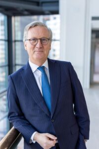 Headshot of man in blue suit