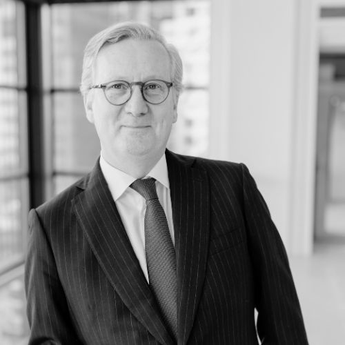 Black and white Headshot of man in blue suit